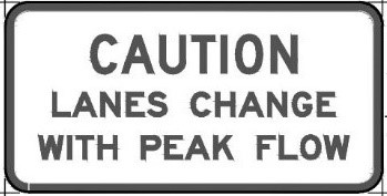 Caution lanes change with peak flow sign
